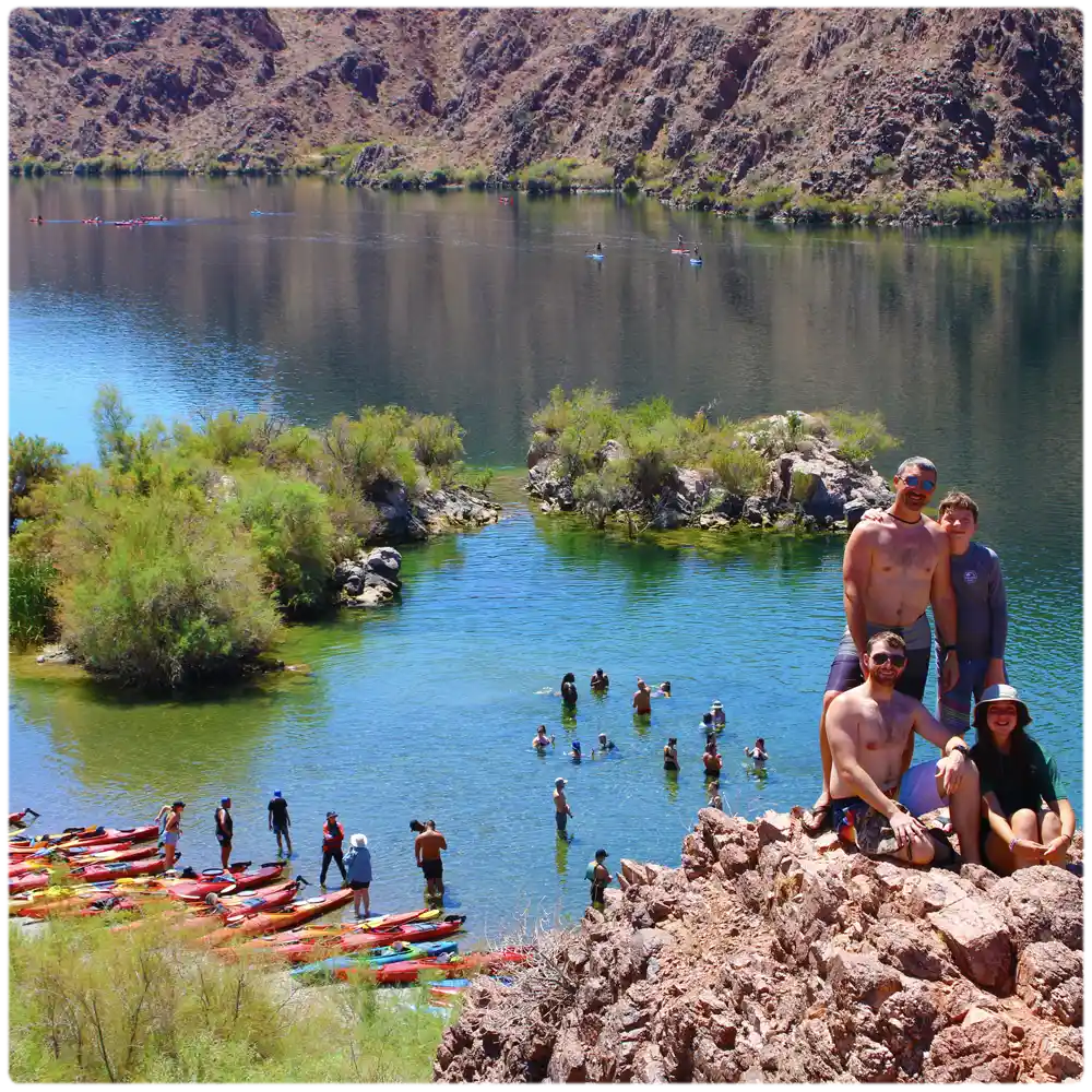 A stunning aerial view of kayakers paddling in Emerald Cove, with crystal-clear waters, scenic canyon cliffs, and group-friendly guided tours on the Colorado River.