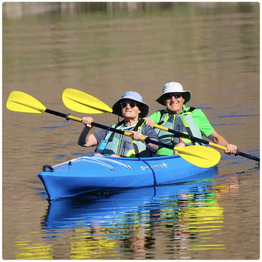 Two paddlers enjoying a tandem kayak rental on the Colorado River, perfect for families and couples exploring Emerald Cove and Willow Beach.