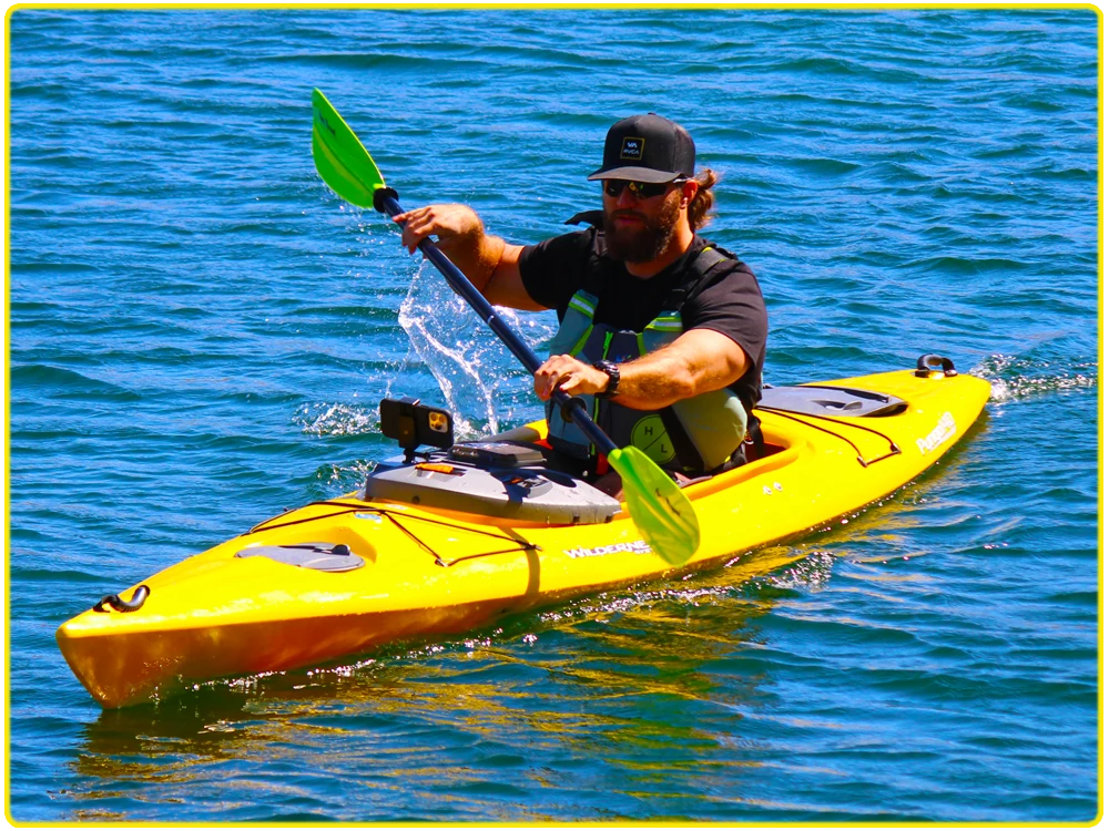 Solo kayaker in a bright yellow kayak paddling through the Colorado River, enjoying calm waters and scenic surroundings.