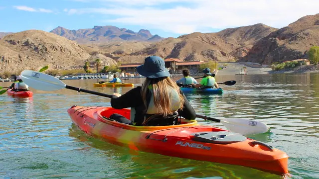 Solo kayaker starting a self-guided paddling adventure from Willow Beach, enjoying the calm waters and canyon views along the Colorado River.