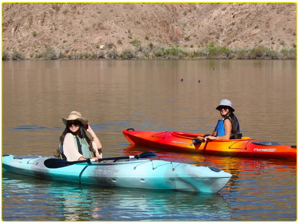 Two guests enjoying self-guided Willow Beach kayak rentals on the Colorado River