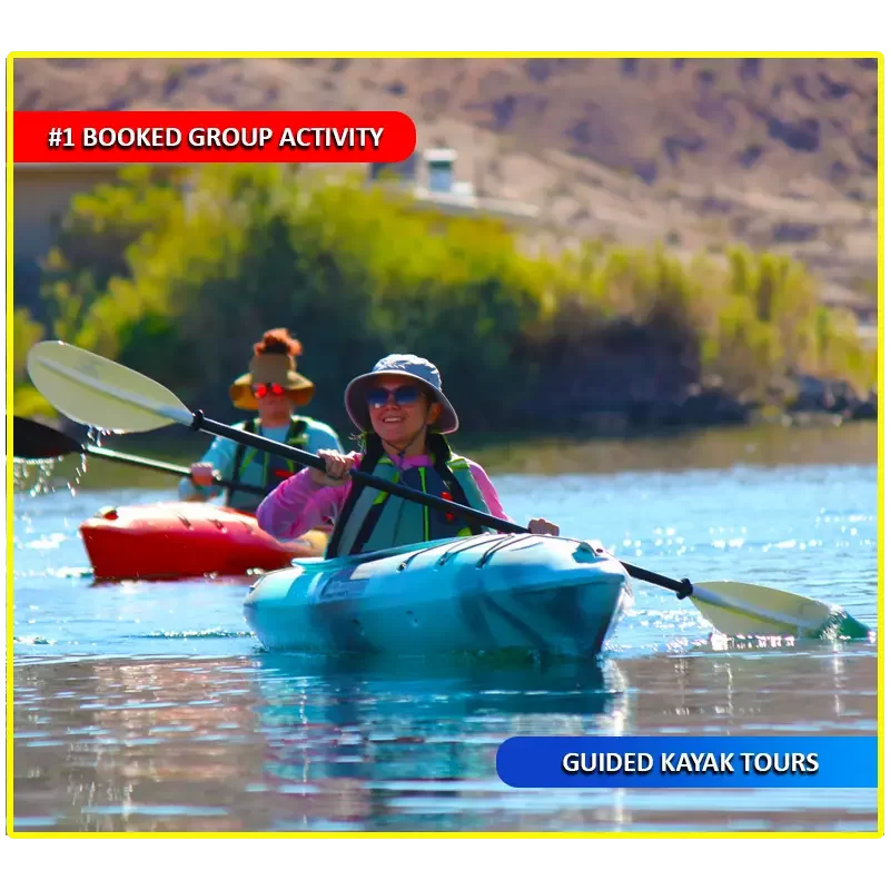 Smiling kayaker leading a group during a guided tour on the Colorado River, exploring scenic waters near Emerald Cove and Willow Beach.